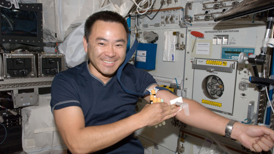 astronaut after having blood drawn from arm