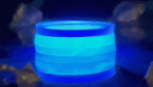 a small wobbly object spinning around and glowing blue