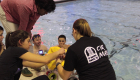 A team in EGR 190 gathers poolside with its submersible robot 