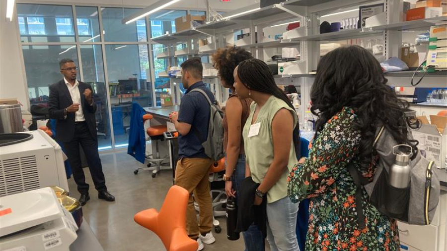 Students tour an engineering laboratory at Duke University with professor Andrew-A Jones