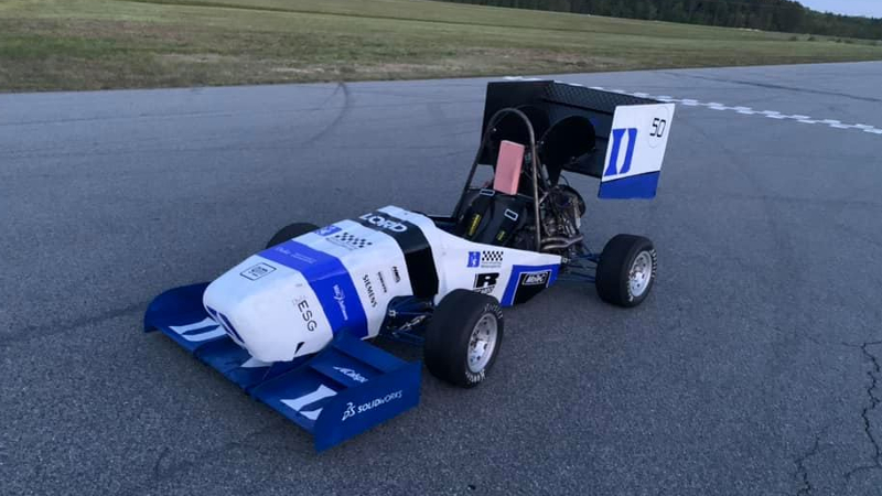 A blue and white race car on a race track