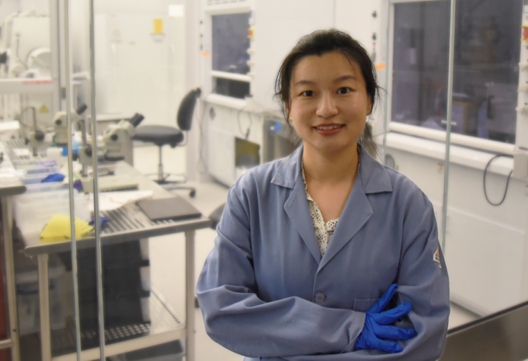 A woman standing in a laboratory