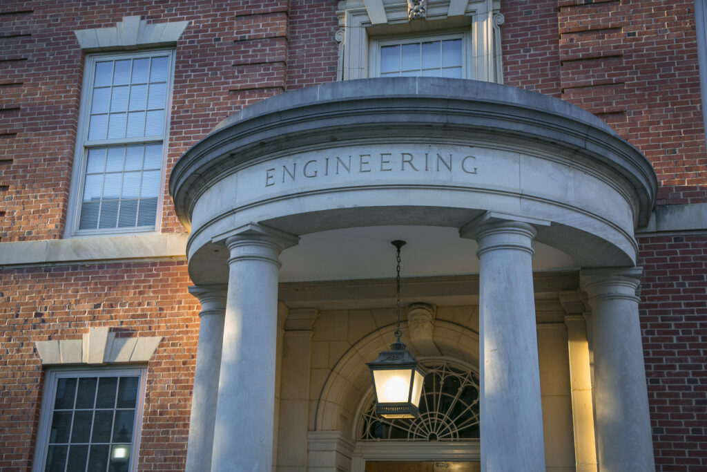 The last rays of the afternoon sun shine on Hudson Hall