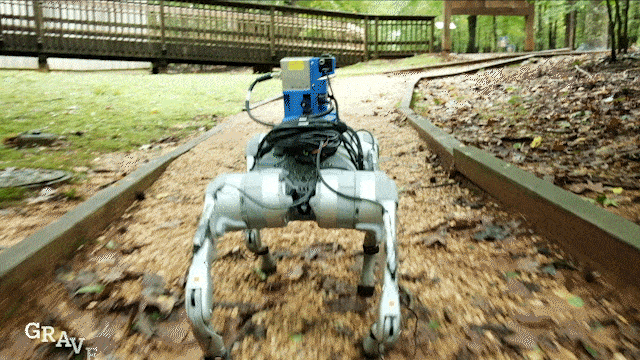 A four-legged, white, dog-like robot walks through four different terrains.