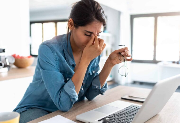 Stock image of stressed woman holding head