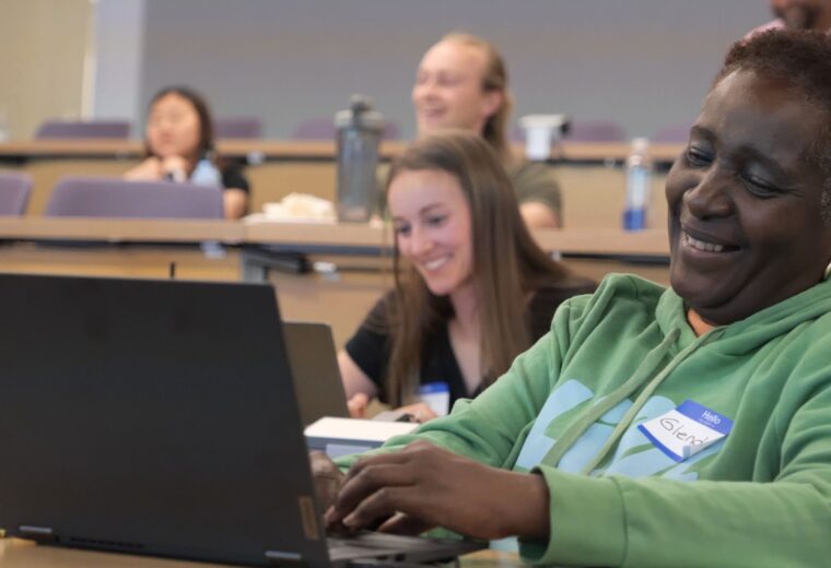participants in an entrepreneur program using their laptops during a presentation