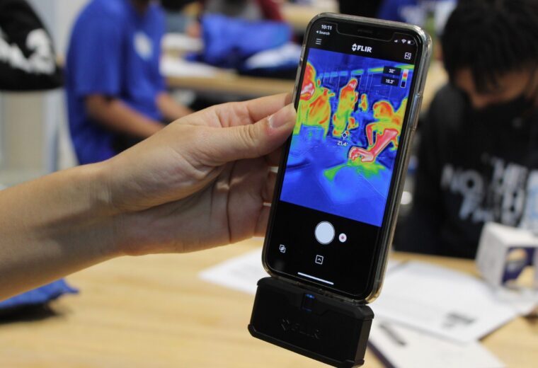 hand holds a smartphone and connected device